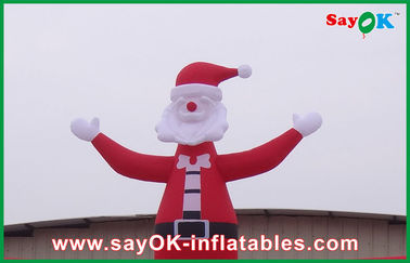 عيد الميلاد في الهواء الطلق الأحمر الكبير نفخ عيد الميلاد القوس مع رجل عيد الميلاد